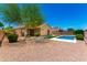 Expansive backyard with a refreshing pool, artificial turf, and low-maintenance desert landscaping at 6557 S Classic Way, Gilbert, AZ 85298
