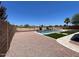 A large backyard with gravel, grass, a pool, and no rear neighbors at 6557 S Classic Way, Gilbert, AZ 85298