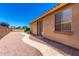 View of the backyard featuring a stone pathway and a well-maintained stucco exterior wall at 6557 S Classic Way, Gilbert, AZ 85298