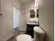 Bathroom featuring a toilet and a single sink vanity with granite countertops and a doorway to the side at 6557 S Classic Way, Gilbert, AZ 85298