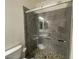 Bathroom featuring tiled shower with sliding glass door and decorative mosaic floor at 6557 S Classic Way, Gilbert, AZ 85298