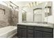 Bathroom with granite countertops, dual sinks, soaking tub, and modern fixtures at 6557 S Classic Way, Gilbert, AZ 85298