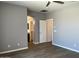 Cozy bedroom featuring wood-look floors, neutral walls, and an en suite bathroom at 6557 S Classic Way, Gilbert, AZ 85298