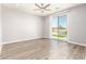 Spacious bedroom featuring a ceiling fan and sliding glass doors leading to the backyard and pool at 6557 S Classic Way, Gilbert, AZ 85298