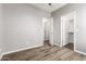 Bedroom with wood look flooring, closet and doors at 6557 S Classic Way, Gilbert, AZ 85298