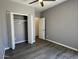 Bedroom featuring vinyl floors, closet with folding doors, and ensuite entry at 6557 S Classic Way, Gilbert, AZ 85298