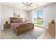 Comfortable bedroom featuring a ceiling fan, sliding glass doors leading to a pool and neutral decor at 6557 S Classic Way, Gilbert, AZ 85298
