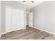 Bedroom with a ceiling fan, closet and doors, and wood look flooring at 6557 S Classic Way, Gilbert, AZ 85298