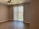 Relaxing bedroom with ceiling fan, wood floors, and sliding glass door to the pool area at 6557 S Classic Way, Gilbert, AZ 85298