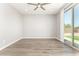 Spacious bedroom featuring a ceiling fan and sliding glass doors leading to the backyard at 6557 S Classic Way, Gilbert, AZ 85298