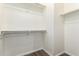 Walk-in closet with built-in racks and wood look flooring at 6557 S Classic Way, Gilbert, AZ 85298