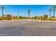Gated entrance to Seville community featuring stone accents, mature trees, and manicured landscaping at 6557 S Classic Way, Gilbert, AZ 85298