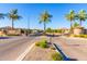 Gated entrance to La Mirada community featuring stone accents, mature trees, and manicured landscaping at 6557 S Classic Way, Gilbert, AZ 85298