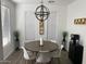 Bright dining room with stylish chandelier, wood-look floors, and large windows at 6557 S Classic Way, Gilbert, AZ 85298