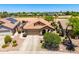 Aerial view of home with tile roof, solar panels, private pool, landscaping, and three-car garage at 6557 S Classic Way, Gilbert, AZ 85298