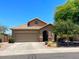 Charming single-Gathering home featuring a two-car garage, tile roof, and desert landscaping at 6557 S Classic Way, Gilbert, AZ 85298