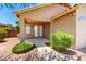 Charming home entrance with a tiled walkway, manicured shrubs, and inviting double doors at 6557 S Classic Way, Gilbert, AZ 85298