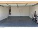 Spacious two-car garage with painted concrete floor and white walls at 6557 S Classic Way, Gilbert, AZ 85298
