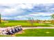 Picturesque golf course with mountains in the background, lush greens, and golf cart parking at 6557 S Classic Way, Gilbert, AZ 85298