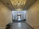 Hallway with unique artwork, designer lighting, benches, and tiled floor, creating a modern and artistic communal space at 6557 S Classic Way, Gilbert, AZ 85298