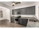 Stylish kitchen with granite countertops, stainless steel appliances, and gray cabinets at 6557 S Classic Way, Gilbert, AZ 85298