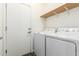 Laundry room featuring a washer and dryer set, a shelf and a door to the garage at 6557 S Classic Way, Gilbert, AZ 85298