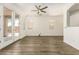 Bright living room features wood-look floors, ceiling fan, and plenty of natural light from the French doors at 6557 S Classic Way, Gilbert, AZ 85298