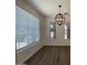 Bright living room with stylish chandelier, wood-look floors, and large windows at 6557 S Classic Way, Gilbert, AZ 85298