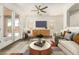 Tastefully furnished living room with a modern aesthetic, wood-look floors, and French doors at 6557 S Classic Way, Gilbert, AZ 85298
