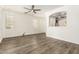 Bright and spacious living room featuring wood-look floors and an open archway at 6557 S Classic Way, Gilbert, AZ 85298
