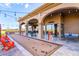 Covered outdoor area with seating, bocce court, ping pong table, and views of the surrounding landscape at 6557 S Classic Way, Gilbert, AZ 85298