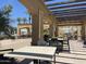 Inviting outdoor patio with pergola, comfortable seating, and lush greenery, perfect for relaxing and enjoying the outdoors at 6557 S Classic Way, Gilbert, AZ 85298