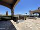 The patio features beautiful tilework and a stunning view of the lush green lawns and picturesque hills at 6557 S Classic Way, Gilbert, AZ 85298