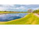 Picturesque pond on the golf course surrounded by lush green grass and a winding cart path at 6557 S Classic Way, Gilbert, AZ 85298