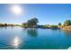Scenic view of a calm pond with a small waterfall and lush green surroundings, perfect for relaxation at 6557 S Classic Way, Gilbert, AZ 85298