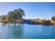 Beautiful pond featuring a small waterfall, mature trees and lush landscaping at 6557 S Classic Way, Gilbert, AZ 85298