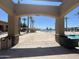 The view from a pergola looking at the pool has palm trees, chairs, and a relaxed resort atmosphere at 6557 S Classic Way, Gilbert, AZ 85298