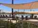 Relaxing poolside lounge area with comfortable seating under a shaded canopy, perfect for enjoying sunny days at 6557 S Classic Way, Gilbert, AZ 85298