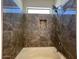 Close up view of the shower featuring a shower head and stylish gray tiling at 6557 S Classic Way, Gilbert, AZ 85298