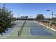 Outdoor tennis courts with manicured landscaping and light posts at 6557 S Classic Way, Gilbert, AZ 85298