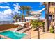 Community pool with fun water slides and a deck with palm trees, perfect for recreation at 6557 S Classic Way, Gilbert, AZ 85298