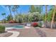 This backyard features a kidney shaped pool and lush landscaping at 8666 E Cheryl Dr, Scottsdale, AZ 85258