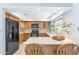 Bright kitchen with wooden cabinets, a breakfast bar, and modern black appliances at 8666 E Cheryl Dr, Scottsdale, AZ 85258
