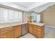 Sunlit eat-in kitchen featuring neutral countertops and a stainless steel dishwasher at 8666 E Cheryl Dr, Scottsdale, AZ 85258