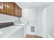 This is a laundry room with a washer, a dryer and cabinet storage at 8666 E Cheryl Dr, Scottsdale, AZ 85258