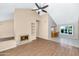 Bright living room boasts high ceilings, a cozy fireplace, and wood-look floors with a breakfast nook at 8666 E Cheryl Dr, Scottsdale, AZ 85258