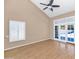 Bright living room featuring wood-look floors, and sliding glass doors leading to outdoor view at 8666 E Cheryl Dr, Scottsdale, AZ 85258