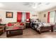 Cozy bedroom with dark wood furniture, including a bed, couch, and coffee table at 11422 W Hidalgo Ave, Tolleson, AZ 85353