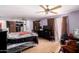 Large bedroom with a fan, laminate floors, and natural light at 11422 W Hidalgo Ave, Tolleson, AZ 85353