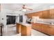 Practical kitchen design with wood cabinets, island, and tile backsplash at 11422 W Hidalgo Ave, Tolleson, AZ 85353